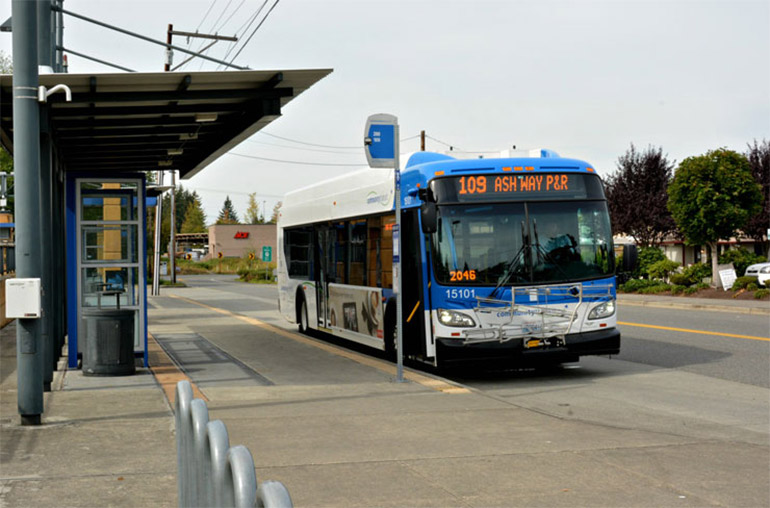 A Community Transit bus waits at a bus stop.