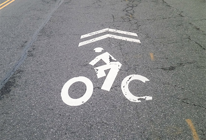 Survey photo 2: Paint markings on a street indicate that bikes ride with traffic at this location.