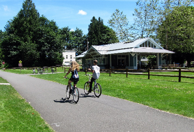 Bicyclists ride on a separated trail.